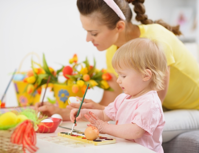 mother and baby making easter decorations